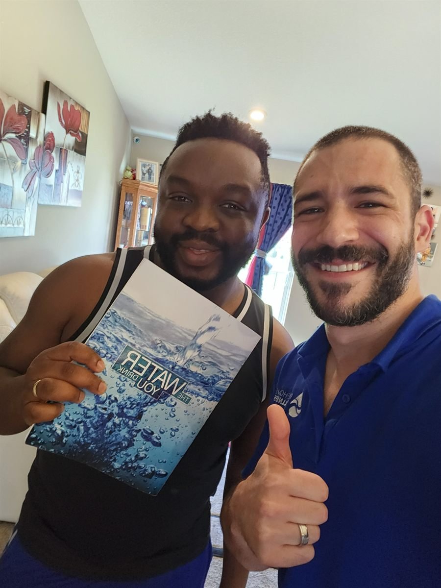 Scott from Pure Home Wellness with a Minnesota customer after a water consultation